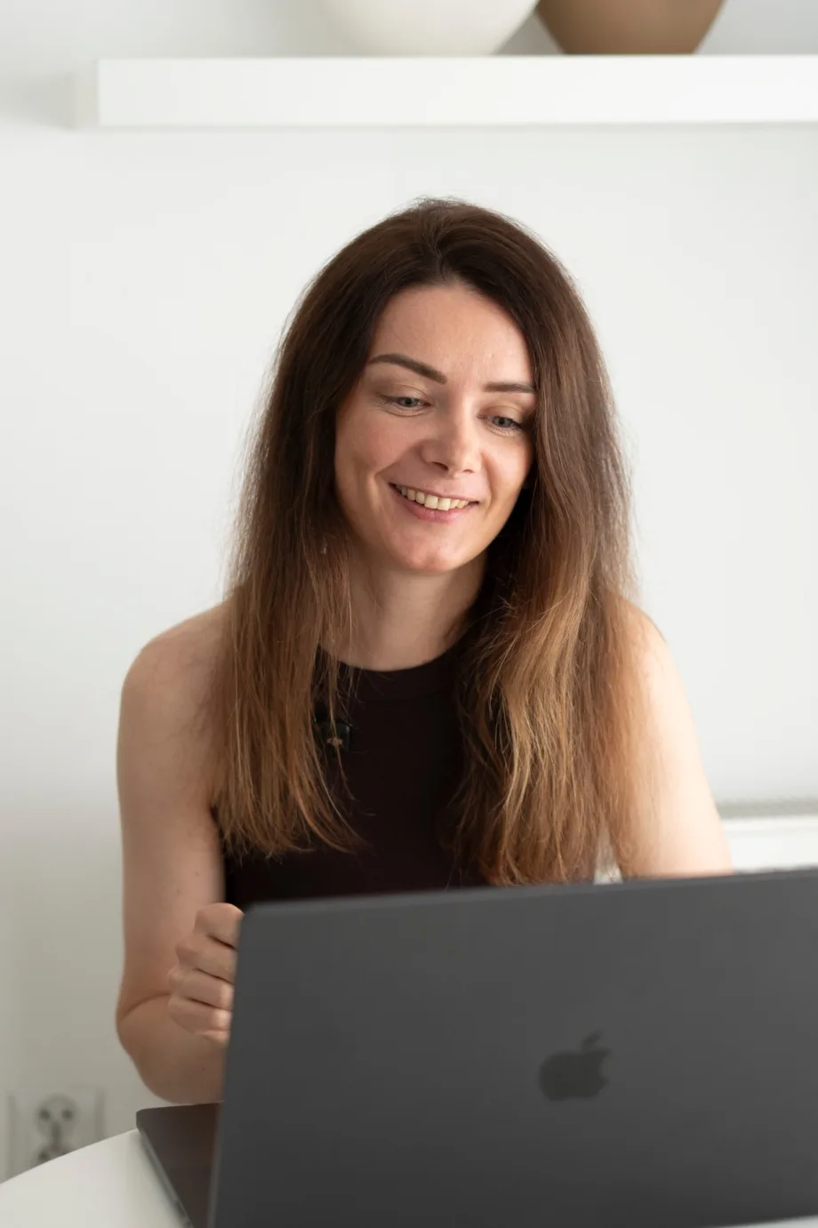 Hanna Honcharenko, AI video creator based in Wrocław, working on a laptop